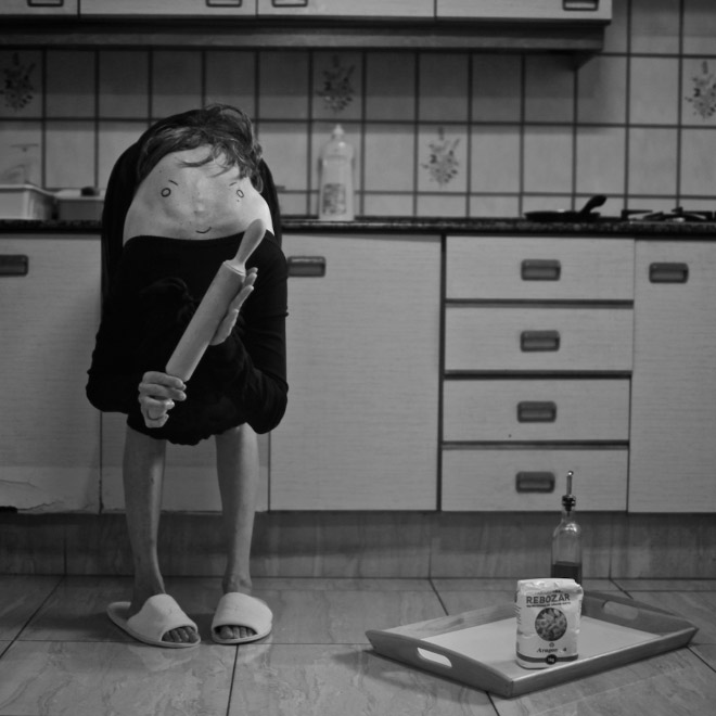 Creepy body art creature standing in the kitchen.