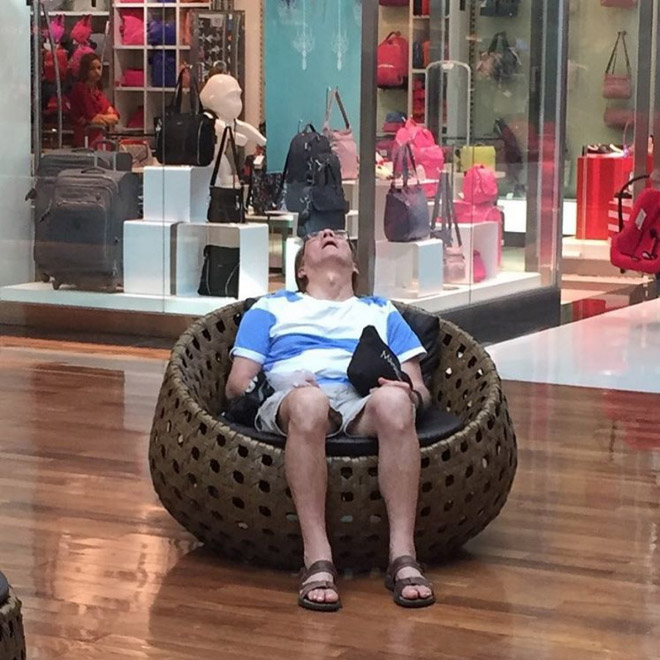 Tired man trapped in the shopping hell.
