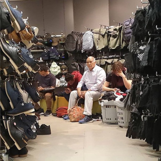 Miserable man trapped in the shopping hell.