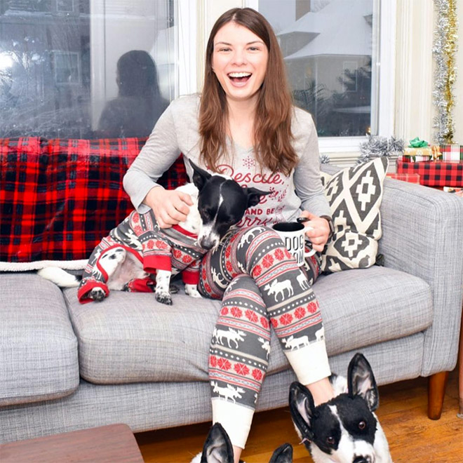 Dog posing with slippers that look just like him.