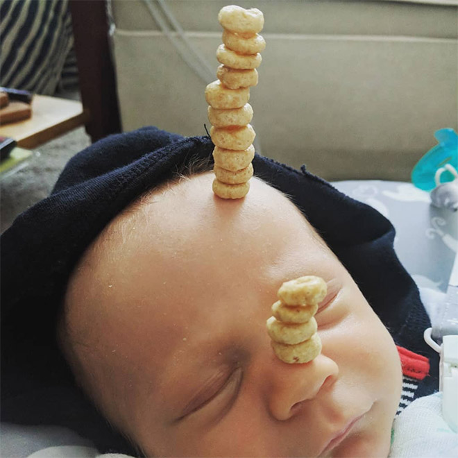 Weird viral trend: stacking Cheerio on babies.