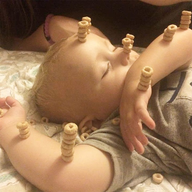 Weird viral trend: stacking Cheerio on babies.