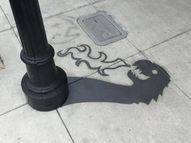 Fake shadow painted by a street artist to confuse people.