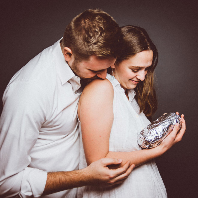 Happy young baby burrito parents.