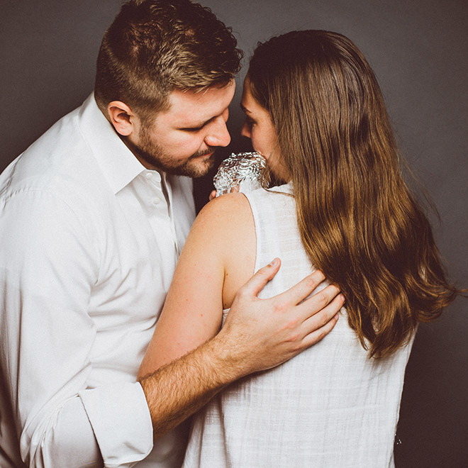 Happy young baby burrito parents.