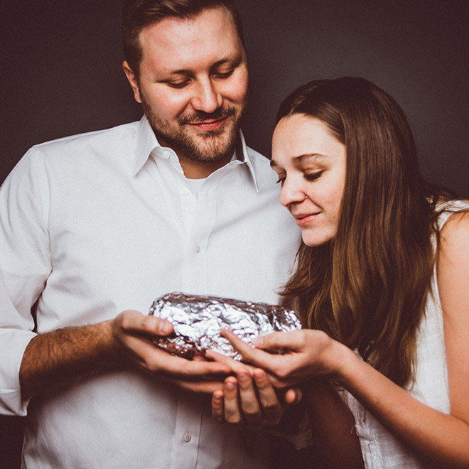 Happy young baby burrito parents.