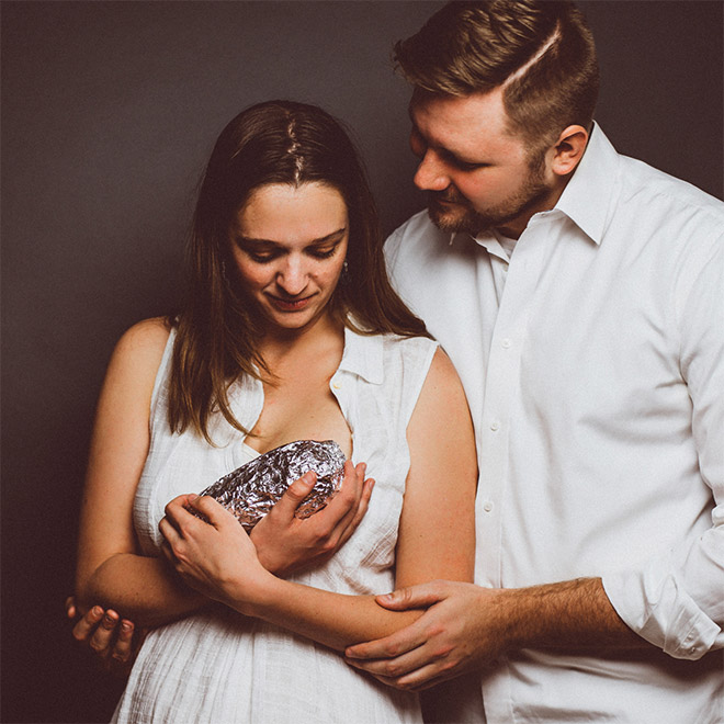 Happy young baby burrito parents.