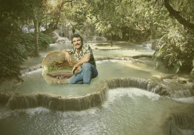 Tom Selleck hanging out with a sandwich in a waterfall.