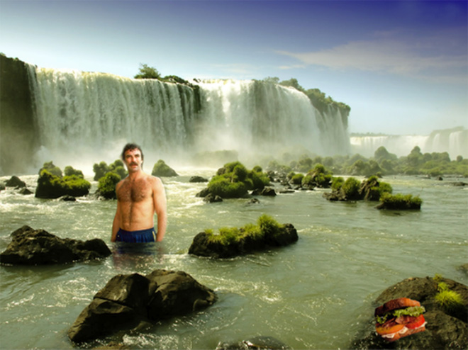 Tom Selleck hanging out with a sandwich in a waterfall.