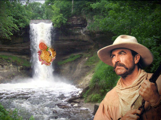 Tom Selleck hanging out with a sandwich in a waterfall.