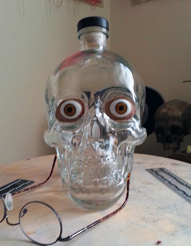 Facial reconstruction of a skull-shaped vodka bottle.