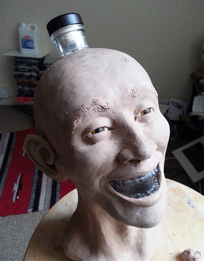 Facial reconstruction of a skull-shaped vodka bottle.