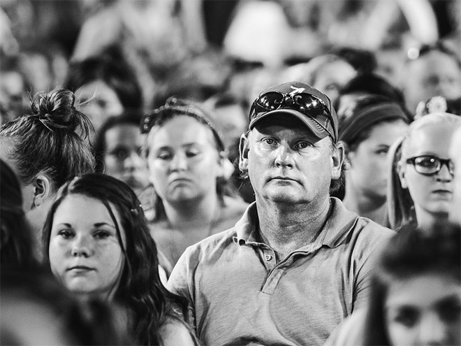 Dad suffering in a concert his daughter likes.