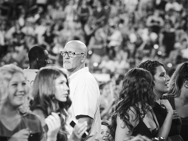 Dad suffering in a concert his daughter likes.