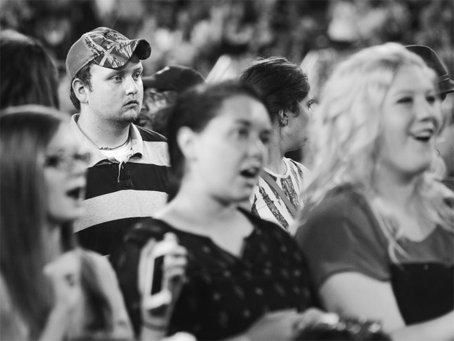 Dad suffering in a concert his daughter likes.